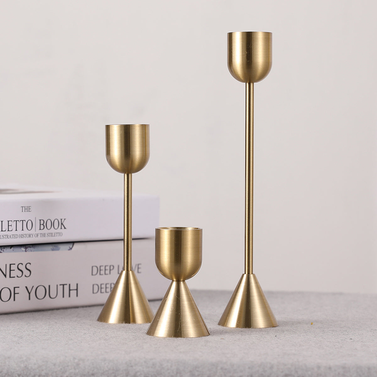 Les Trois Flammes taper holders on a table