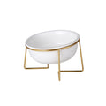 White tilted ceramic cat bowl on a gold stand