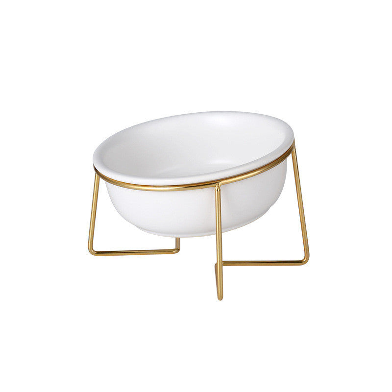 White tilted ceramic cat bowl on a gold stand