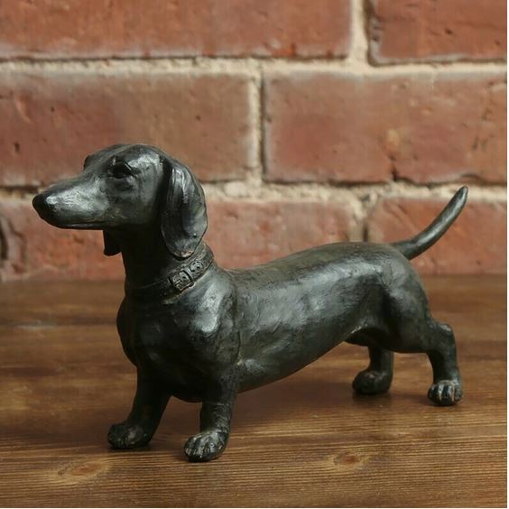 Le Teckel dachshund figurine on a wooden shelf