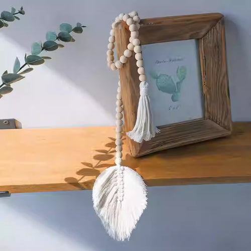 La Feuille tassel hanging beside a frame