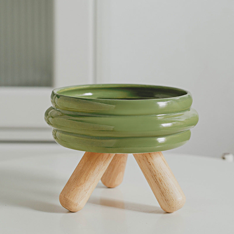 Le Tabouret: Ringed ceramic bowl on wooden legs